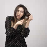 beautiful young woman holding her healthy shiny hair scaled