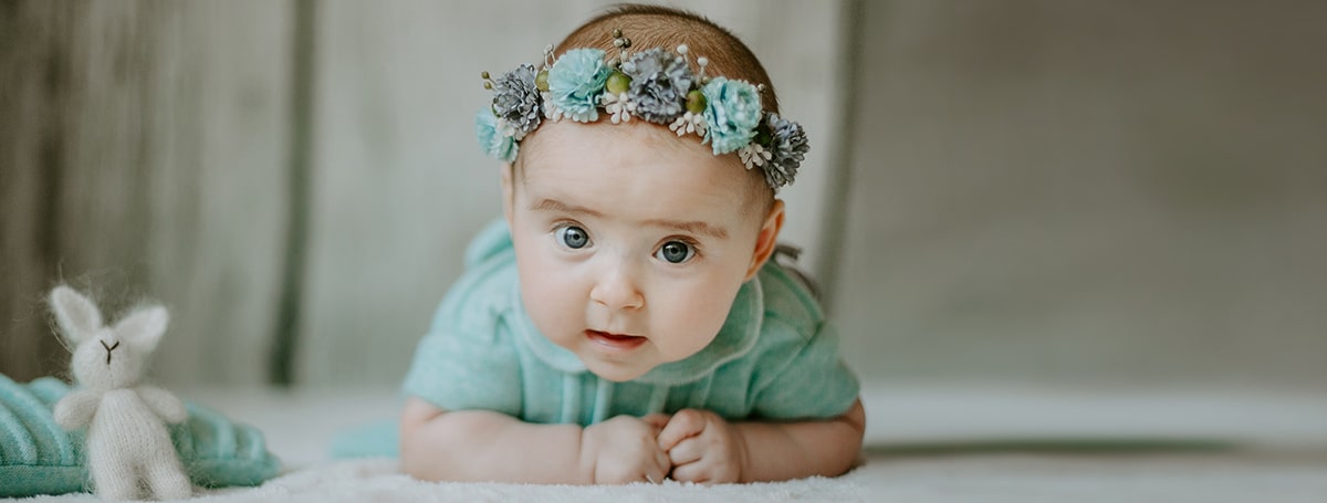 close up view little female girl lying bed looking camera